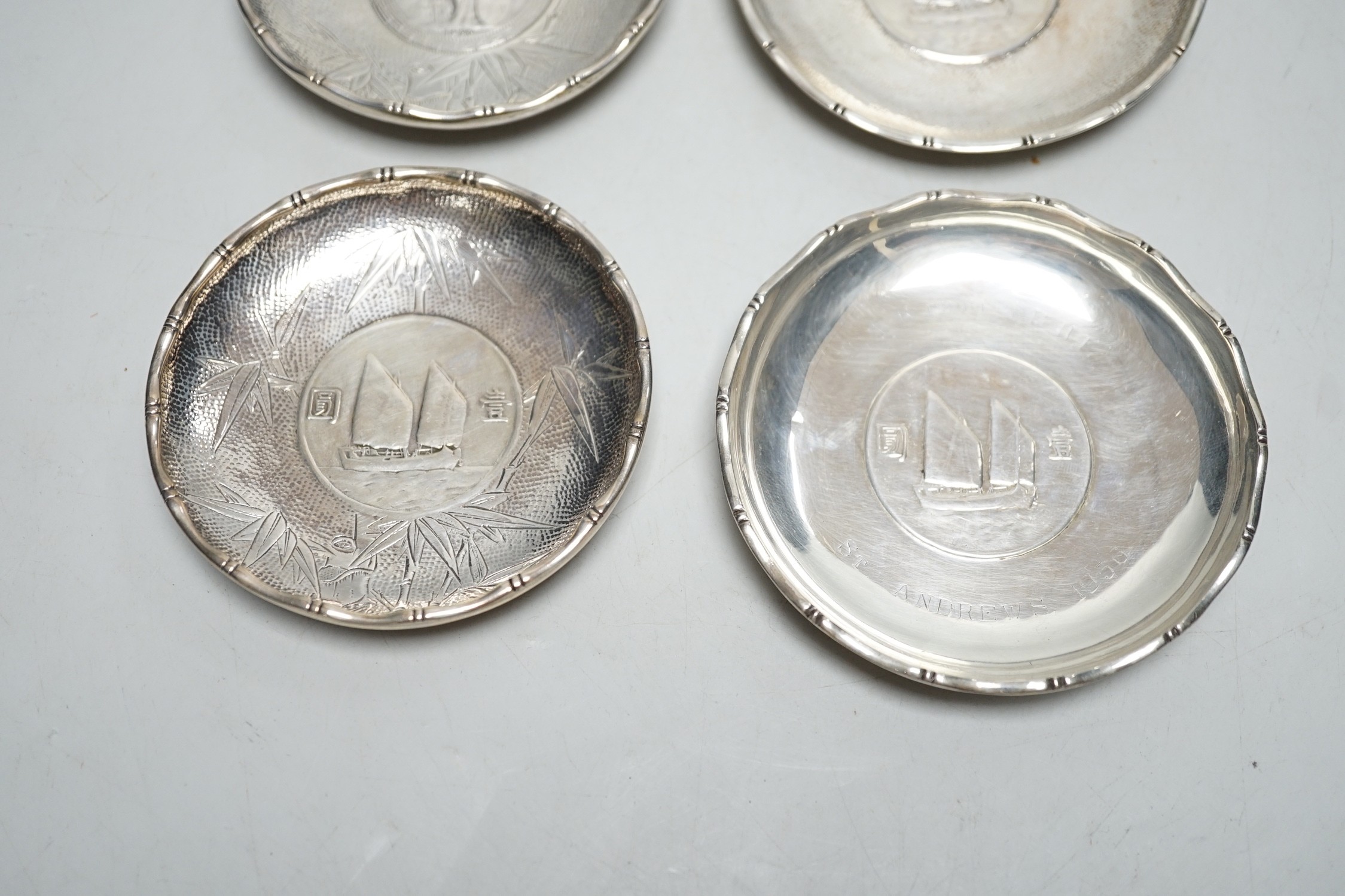 Three Hong Kong white metal mounted Republic of China coin dishes and a similar One Dollar 1930 dish, largest diameter 9cm.